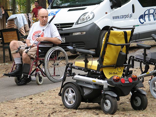 Mężczyzna na wózku patrzy na wózki elektryczne