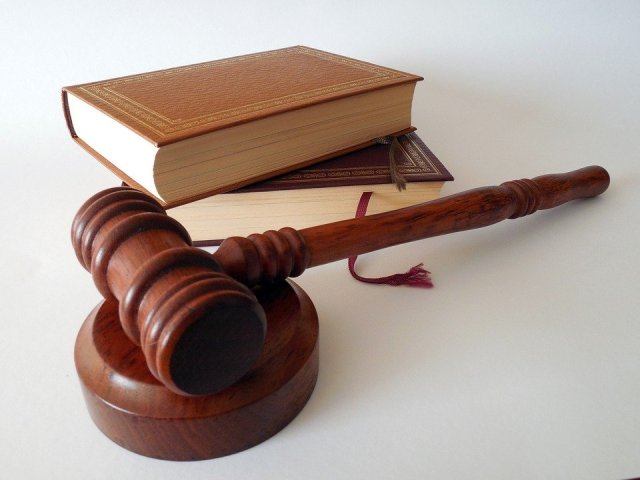 Na zdjęciu sędziowski młotek i prawnicze książki - źródło Pixabay